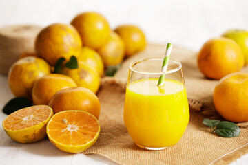 Fototapeta na wymiar Fresh made orange juice from organic oranges in a glass
