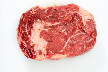 Close-up of one rib eye steak over white background. Aerial view