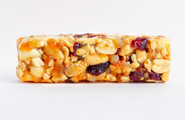 Granola bar. Healthy sweet dessert snack. Sesame, hazelnut, sunflower, cranberries, dry berries, in honey. Top view