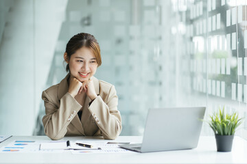 Business woman work process concept. Young woman working university project with generic design laptop. Happy excited woman at home workstation. Blurred background, film effect.