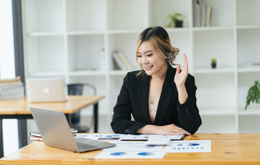 Fototapeta premium Asian business woman talking to colleague team about plan in video conference. Group of multiethnic business people using computer for online meeting in video call conference. Smart working from home.