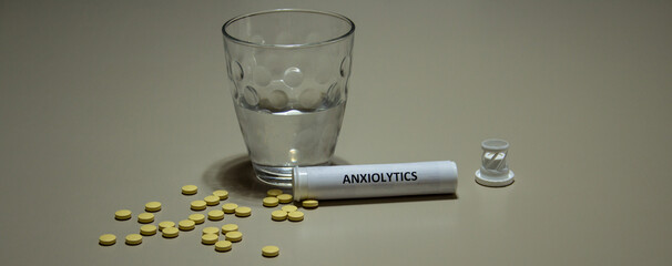 glass of water and anxiolytic pills. Remedy for those suffering from anxiety and panic attacks