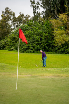 Golfer aiming at the final hole to win the tournament