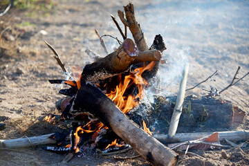 Flames and smoke from burning firewood to cure the cold in rural Thailand