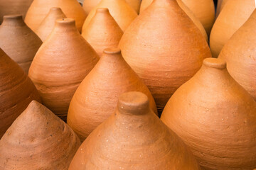 Fototapeta na wymiar Many clay pots in the pottery workshop close-up