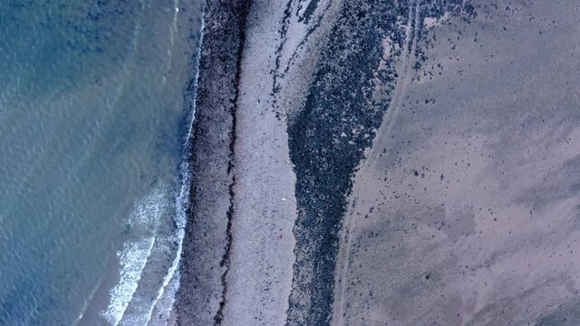 AERIAL - Top down view of coastline of Island Davaar, Kintyre, Scotland, rising