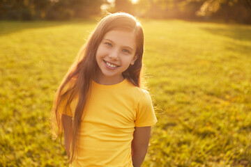 Smiling girl looking at camera in park