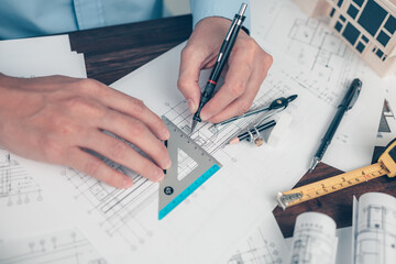 Architect engineer use pen and  angle protector drawing design working on bueprint. House planning design and construction concept. - obrazy, fototapety, plakaty