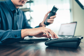 businessman dialing desk phone in the office. Telephone dialing ,contact and customer service.