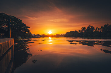 sunset at coast of the river. Nature landscape and reflection sunset.