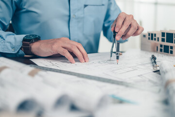 Architect engineer use compass drawing design working on bueprint. House planning design and...