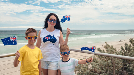 Happy mother and kids with Australian flags celebrating Australia Day