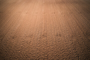 Texture brown red color aerial view. Texture of arable land top view. Plowed land drone view. Arable land top view.