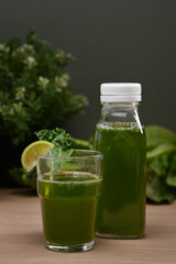 Fresh green smoothie from fruit and vegetables for healthy lifestyle  on wooden table. Healthy food concept.