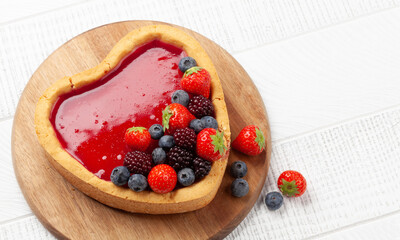 Heart shaped sweet cake with berries