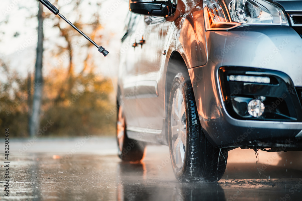 Poster Manual car wash with white soap, foam on the body. Washing Car Using High Pressure Water.