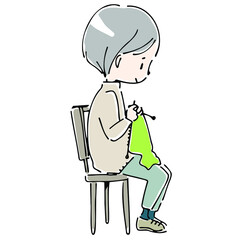 椅子に座って編み物をする女性