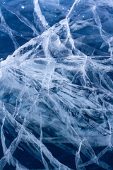 Natural texture of pure ice with cracks. Blue thick ice.