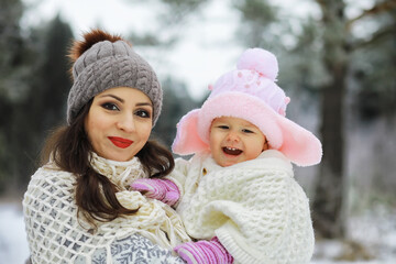 Fototapeta premium Happy family playing and laughing in winter outdoors in the snow. City park winter day.
