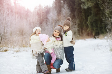 Happy family playing and laughing in winter outdoors in the snow. City park winter day.