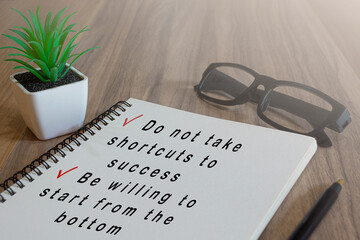 Text on white notepad on wooden desk. Success concept