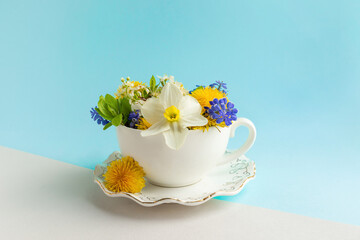 Beautiful flowers composition in vase - cup on modern minimal background. Spring nature background. Springtime summer concept flowers composition bloom delicate flowers. Flower pattern