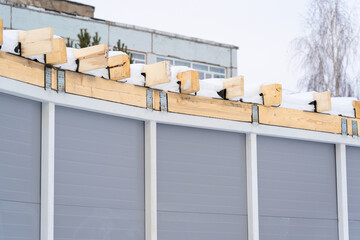Rafter system in a warehouse building made of mineral wool insulated sandwich panels in winter