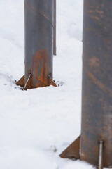 round metal column support on the construction site in winter, selective focus