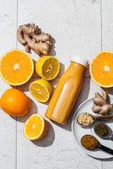 Ginger, lemon and orange juice in a bottle. Detox drink concept.
