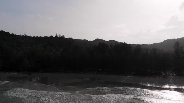Backwards Reveal Aerial Drone Shot Of Bavang Jamal Beach, Next To The Tip Of Borneo. Showing The Beach And Waves Hitting The Sand. Kudat, Malaysian Borneo