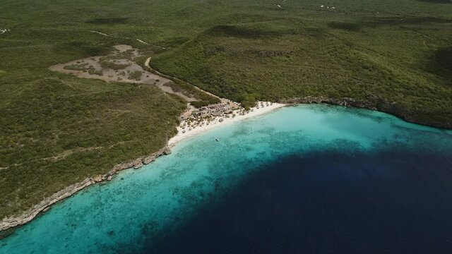 High altitude drone shot at the caribbean beach of the Kenepa in Curacao Island