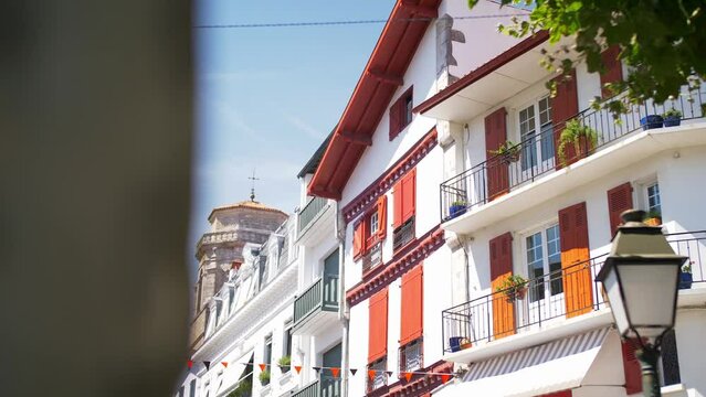 European Basque French Houses on the coast, bright sunny day with trees, handheld drifting shot.