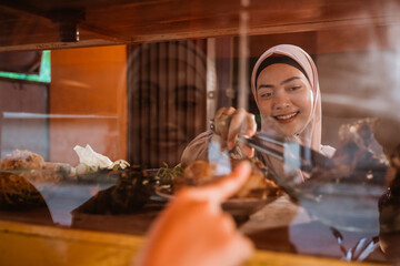 muslim couple ordering food to break fasting in ramadan