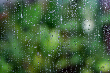  Water drop or Rain drop on glass, Water droplets on frosted glass walls or translucent windows get wet from the rain in the rainy season.  © surasak