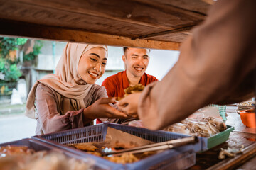 Fototapeta na wymiar muslim couple ordering food to break fasting in ramadan
