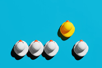 Rubber duck with competitive advantage stands out from the crowd. Successful business startup or...
