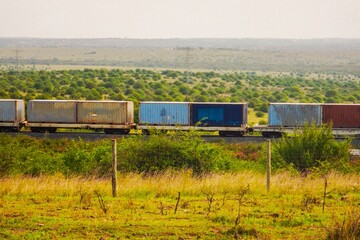 Shipping containers aboard the Nairobi Mombasa Railway seen from Nairobi National Park, Kenya