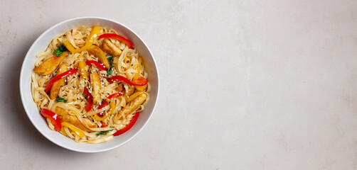 Udon noodles with chicken, pepper and sesame. Chinese food.