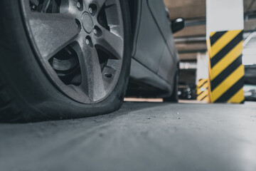 Obraz na płótnie Canvas flat tire close up. abandoned car in the parking lot.