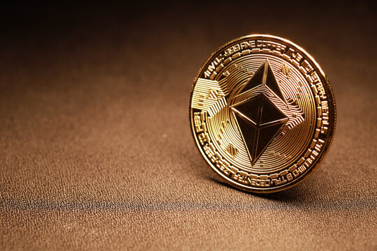 PENANG, MALAYSIA - 24 JAN 2022: Ethereum gold coin and defocused background. Ethereum is a decentralized, open-source blockchain with smart contract functionality.