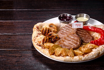 Delicious juicy chicken steak with baked potatoes, mushrooms and sauces