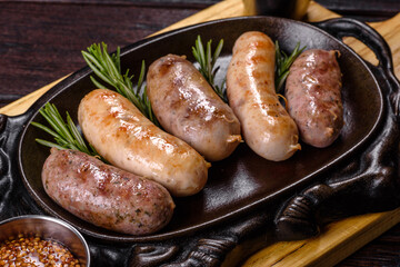 Delicious fresh juicy sausages grill with red sauce in a beautiful cast iron pan
