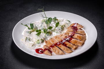 Close up of grilled duck breast covered with sweet red fruit sauce