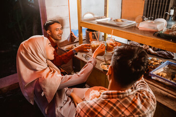 muslim asian friend cheering their glass for break fasting