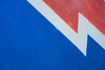 The image of the lightning is white. A zigzag separates the blue and red fields. Diagonal image...
