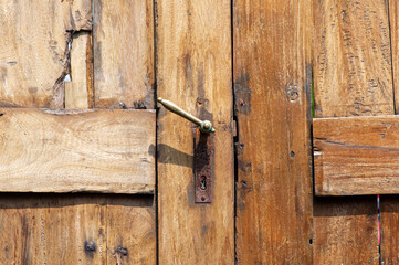 Old teak wood door with rusty door handle