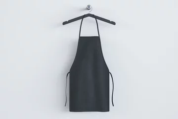 Fotobehang Empty black kitchen apron on hangers. Light background. Chef and cooking concept. Mock up place. 3D Rendering. © Who is Danny