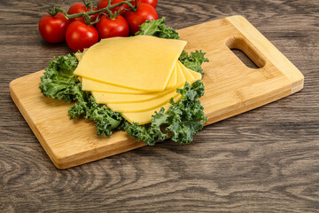Sliced Gauda cheese over board