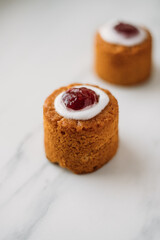 Runebergin torttu, famous Finnish Runeberg cake tart pastry made of almonds, rum, raspberry jam, pink background. Baked on February 5, Runeberg's birthday