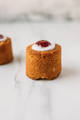 Runebergin torttu, famous Finnish Runeberg cake tart pastry made of almonds, rum, raspberry jam, pink background. Baked on February 5, Runeberg's birthday